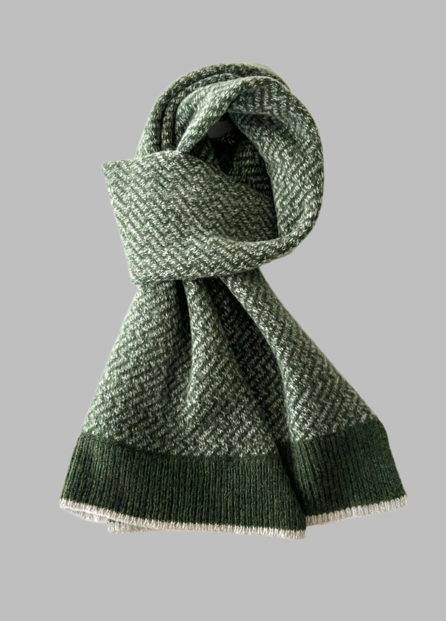 A marled merino lambswool Nordic zigzag pattern scarf in green FinesseKnits