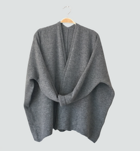 Made from soft, high-quality Merino lambswool, our edge-to-edge boxy style uniform grey cardigan is perfect for any occasion. No buttons for easy wear and a modern look.